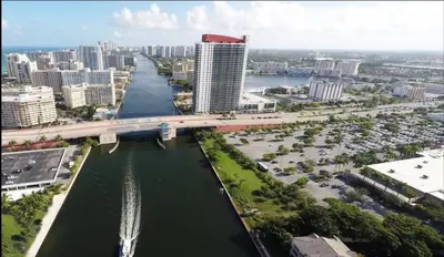 an aerial view of a city with a bridge over a river at Beach, pool, and Gym 2B 2B Near Gulfstream & Mall in Hallandale Beach