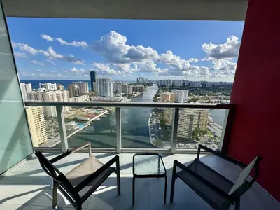 a balcony with two chairs and a view of a city at Getaway in Miami 2B 2B beachfront near Aventura 3003 in Hallandale Beach