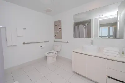 a white bathroom with a toilet and a sink at Your Paradise in Miami Beach Gym and Pool 2b 2b 1507 in Hallandale Beach