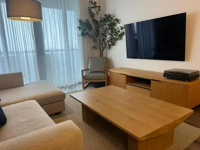 a living room with a couch and a tv at Miami Beach Cozy 1B withe Pool and Beach Service1507 in Hallandale Beach