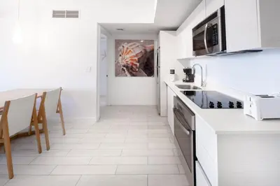 a kitchen with white cabinets and a counter top at 2B 2B Beautiful Apt in Hallandale Beach with Beach Service 2605 in Hallandale Beach