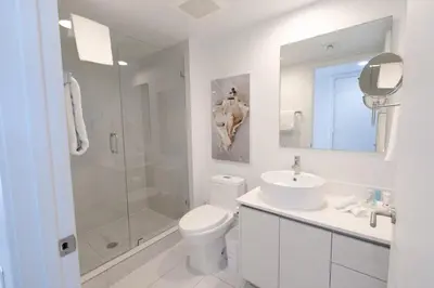 a white bathroom with a shower and a toilet and a sink at 2B 2B Beautiful Apt in Hallandale Beach with Beach Service 2605 in Hallandale Beach