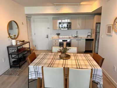 a kitchen and dining room with a table and chairs at Beach Apt with Full kitchen and King size bed in Hallandale Beach