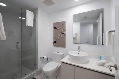 a bathroom with a toilet and a sink and a shower at Relax in Miami 2B 2B Beach and Pool with Drinks in Hallandale Beach