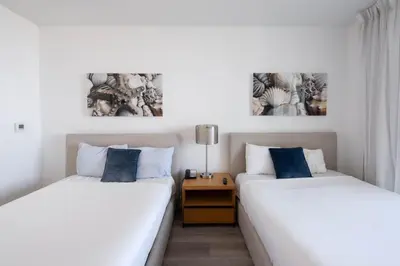 two beds sitting next to each other in a room at Relax in Miami 2B 2B Beach and Pool with Drinks in Hallandale Beach