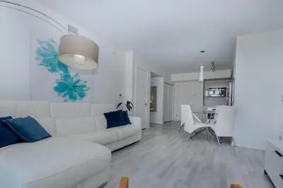 a white living room with a white couch and a table at Enjoy Miami Beach Pool and Restaurant 2B 2B 2007 in Hallandale Beach