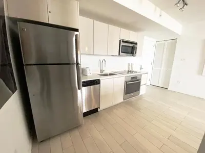 a large kitchen with a stainless steel refrigerator at 2610 Enjoy Miami 2B 2B, Pool, Beach & Mall in Hallandale Beach