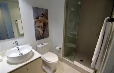a bathroom with a toilet and a sink and a shower at 2610 Enjoy Miami 2B 2B, Pool, Beach & Mall in Hallandale Beach