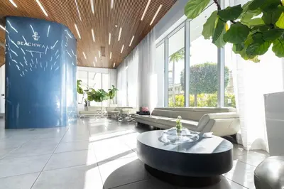 a living room with a couch and a table at Luxury Miami Apartment Beach and Poolside drinks 2308 in Hallandale Beach
