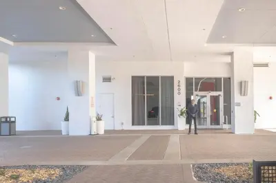 a man in a suit standing outside of a building at Suite with Beach Serv Pool and close to Aventura Mall 2808 in Hallandale Beach