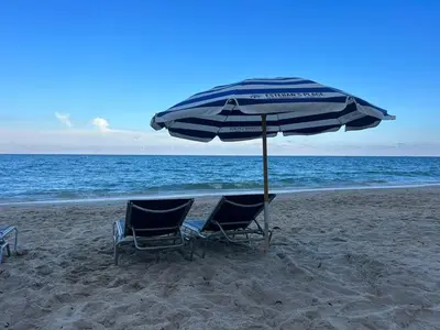 two chairs and an umbrella on the beach at 2b 1b Hallandale Beach Studio with heated Pool 2610 in Hallandale Beach