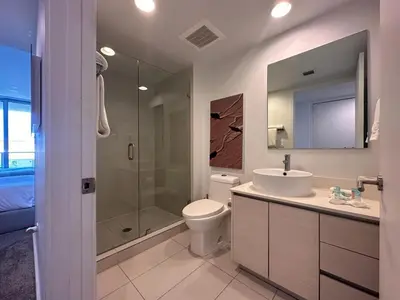 a bathroom with a toilet and a sink and a shower at Studio Miami with Beach and Lounge Chairs 2 Full beds 2403 in Hallandale Beach