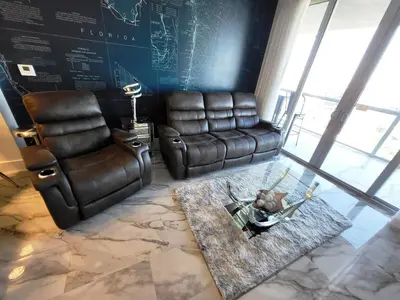 a living room with a leather couch and a chair at 2b 2b Apmt Hallandale Beach 2805 in Hallandale Beach