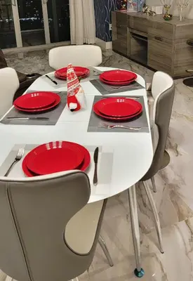 a white dining table with red plates on it at 2b 2b Apmt Hallandale Beach 2805 in Hallandale Beach