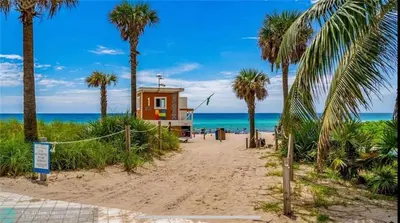 a small house on the beach with palm trees at Miami Beautiful with kitchen, pool and mall Apmt 1B 1B 1408 in Hallandale Beach