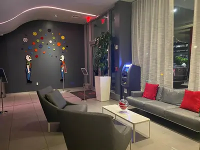 a living room with couches and a wall with a climbing wall at Miami Apartment 2 Full beds with Beach service, pool and gym 2007 in Hallandale Beach