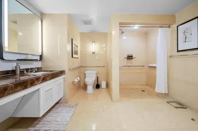 a bathroom with a toilet and a sink and a shower at Oceanfront Ritz-Carlton 1 Bedroom Luxury Residence in Fort Lauderdale
