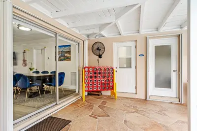 a dining room with a table and chairs and a clock at Sleeps 12 Private Pool & Gameroom near Casino, Beaches & Hard Rock Stadium in Hollywood