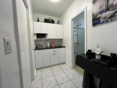 a small kitchen with white cabinets and a counter at Guest Suite w free parking at 7 min to Miami international airport in Miami