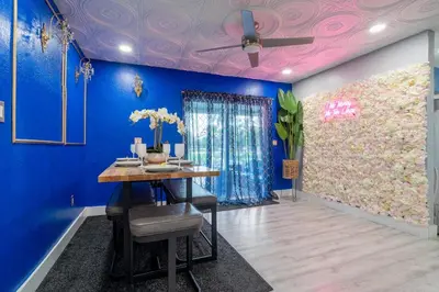 a dining room with blue walls and a ceiling with a ceiling fan at Renovated Sept 2024! Pool - Mini Golf - Volleyball in Joe Robbie Stadium Heliport