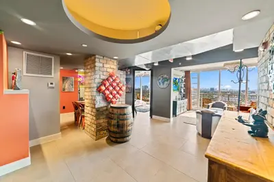 a living room with a fireplace and a large window at Hollywood Beach Speakeasy Condo in Hollywood