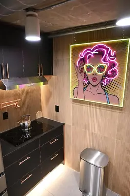 a kitchen with a painting of a woman with sunglasses at Hollywood Beach Speakeasy Condo in Hollywood