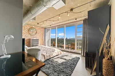 a bedroom with a bed and a large window at Hollywood Beach Speakeasy Condo in Hollywood
