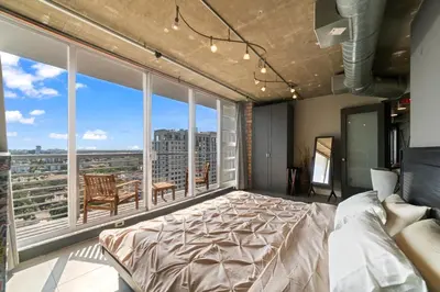 a bedroom with a large bed and a large window at Hollywood Beach Speakeasy Condo in Hollywood