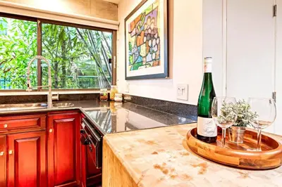 a kitchen with a bottle of wine and two glasses at Piano House on the Water in Fort Lauderdale