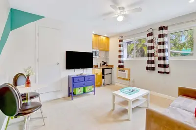 a living room with a couch and a tv at Studio in Las Olas near FL Beach in Fort Lauderdale