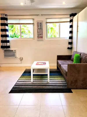 a living room with a couch and a coffee table at Studio in Las Olas near FL Beach in Fort Lauderdale
