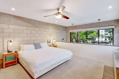 a bedroom with a white bed and a window at Singer House on the Water in Fort Lauderdale