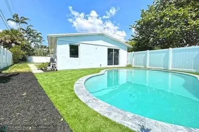 a swimming pool in the backyard of a house at Chic 3BR 2BA Getaway with Private Pool Oasis in Fort Lauderdale