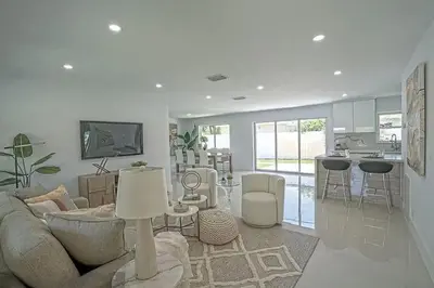 a living room with a couch and a kitchen at Chic 3BR 2BA Getaway with Private Pool Oasis in Fort Lauderdale