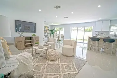 a living room with a couch and a table at Chic 3BR 2BA Getaway with Private Pool Oasis in Fort Lauderdale