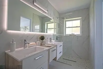 a white bathroom with a sink and a shower at Chic 3BR 2BA Getaway with Private Pool Oasis in Fort Lauderdale
