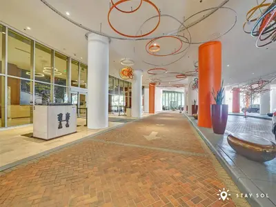 an empty lobby with orange columns and a large room at Stylish Apt - Beach View - Resort Access in Hollywood