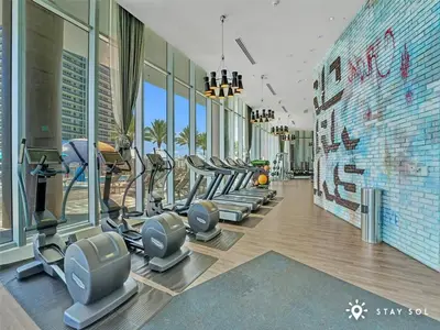 a gym with treadmills and ellipticals in a building at Stylish Apt - Beach View - Resort Access in Hollywood