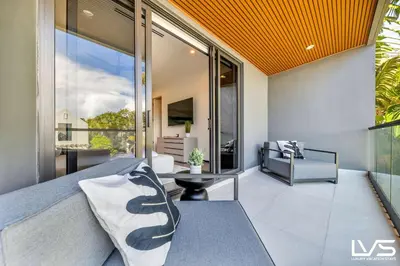 a living room with a couch and a large window at Villa Enclave- Brand New Luxe Las Olas Beach Villa in Fort Lauderdale