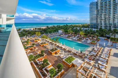 an aerial view of a resort with a pool and the ocean at 1 Bedroom Private Residence at Roney Palace - 607 in Miami Beach