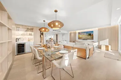 a dining room and living room with a table and chairs at 1 Bedroom Plus Den Private Residence at Roney Palace -608 in Miami Beach