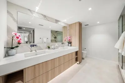 a bathroom with two sinks and a large mirror at 1 Bedroom Plus Den Private Residence at Roney Palace -608 in Miami Beach