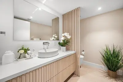 a bathroom with a sink and a toilet at 1 Bedroom Plus Den Private Residence at Roney Palace -608 in Miami Beach