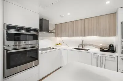 a kitchen with white cabinets and stainless steel appliances at 5 Bedrooms Private Residence at Roney Palace -6078 in Miami Beach