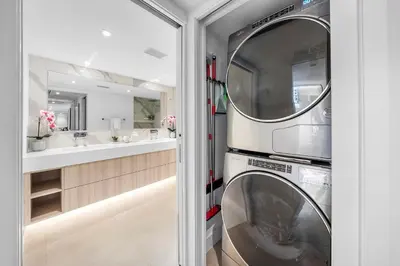 a washer and dryer in a bathroom with a mirror at 5 Bedrooms Private Residence at Roney Palace -6078 in Miami Beach