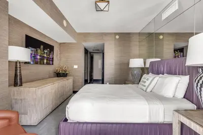 a bedroom with a large bed with a purple headboard at Stunning Apartment at Icon with Bay Views-Pool-Gym-Spa in Miami