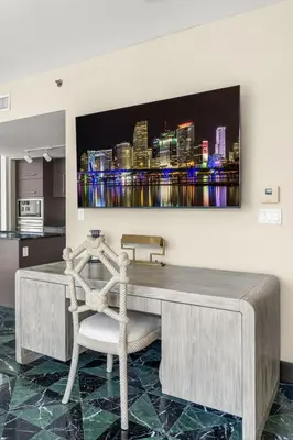 a desk in a kitchen with a television on the wall at Stunning Apartment at Icon with Bay Views-Pool-Gym-Spa in Miami