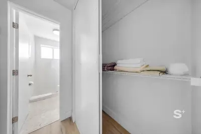 a bathroom with white walls and a mirror at Modern Studio - Gym & Parking Close to Aventura in Miami