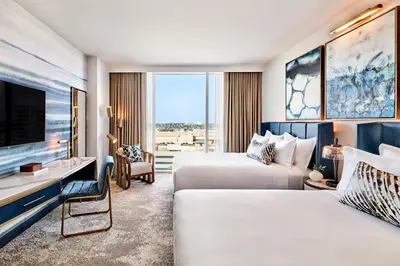 a hotel room with two beds and a tv at Omni Fort Lauderdale Hotel in Fort Lauderdale