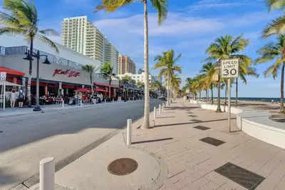 a city street with palm trees and a speed limit sign at NEW Studio at Eden Collection Steps to Beach 1106 in Fort Lauderdale